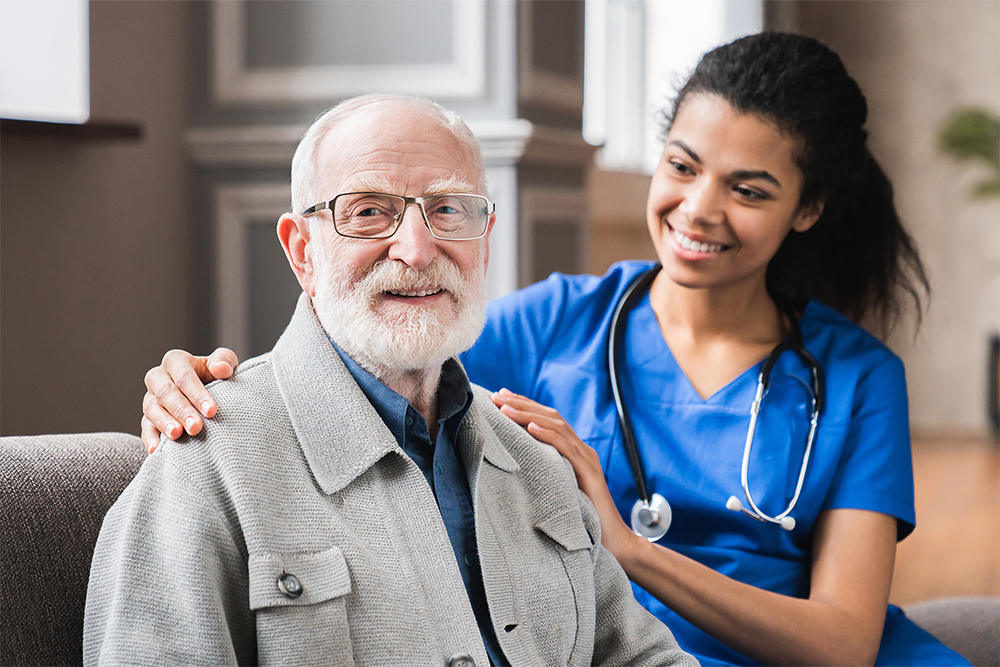 Older man sitting with a nurse