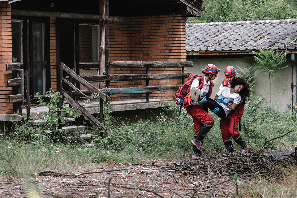 Person being rescued in from a house in a natural disaster.